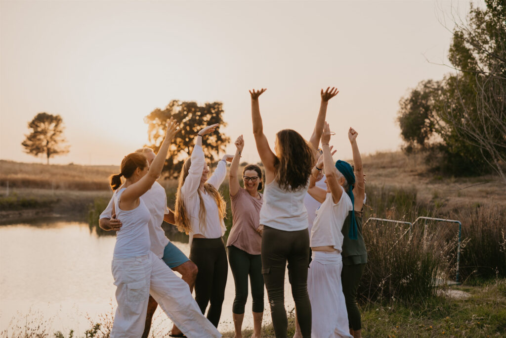 group of people having fun by the pond